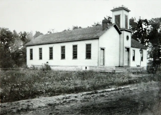 Black-and-white photograph of the white frame church building in 1914